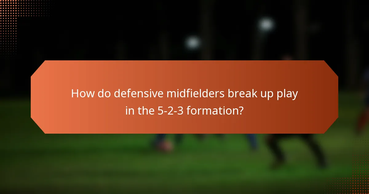 How do defensive midfielders break up play in the 5-2-3 formation?