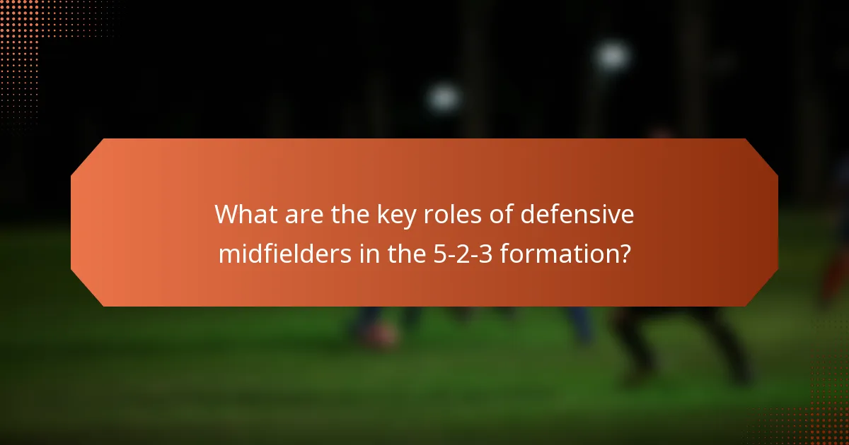 What are the key roles of defensive midfielders in the 5-2-3 formation?